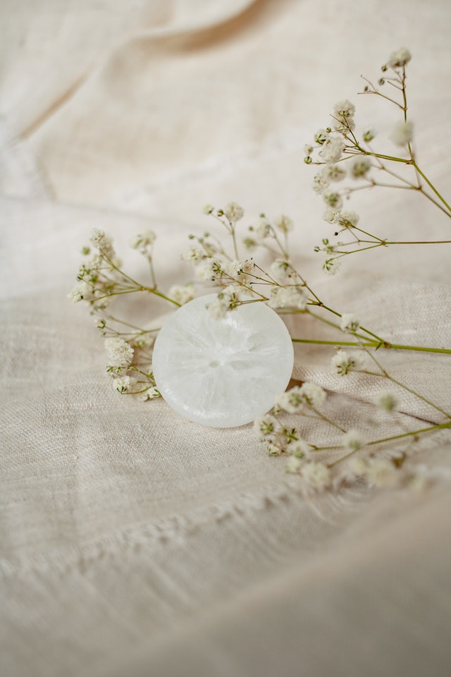 clear deoderant bar on linen next to flowers