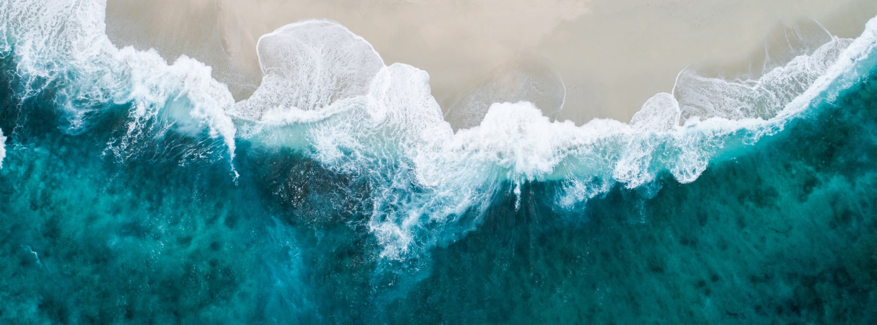 ocean waves crashing onto sand